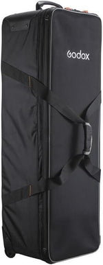 Black Godox camera bag with a strap on a black background
