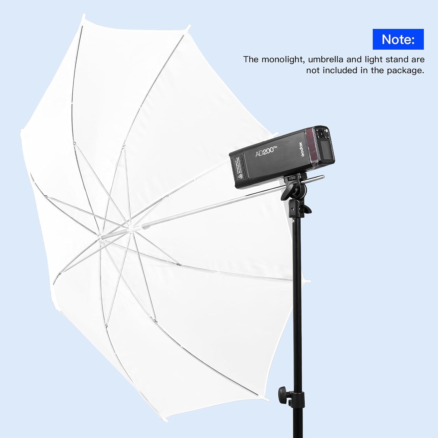 White photography umbrella with a light stand and monolight on a light blue background