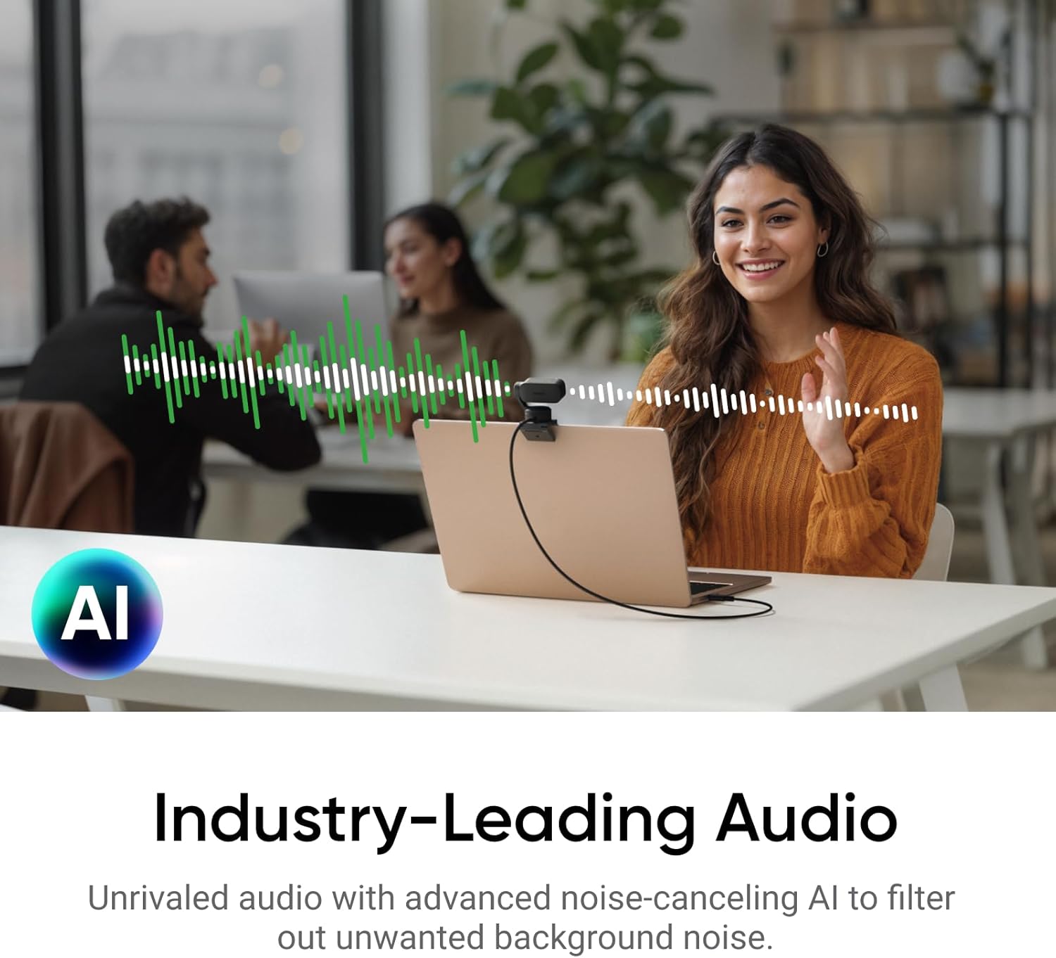 Woman using a laptop with AI audio technology in an office setting