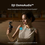 Woman holding a device with 'DJI OsmoAudio' text, indicating audio connection feature.