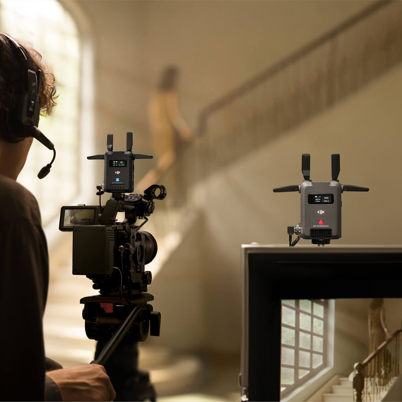 Person with video camera filming another person in a room.