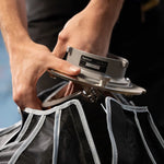 Person using a hair cutting machine on a client with a blurred background