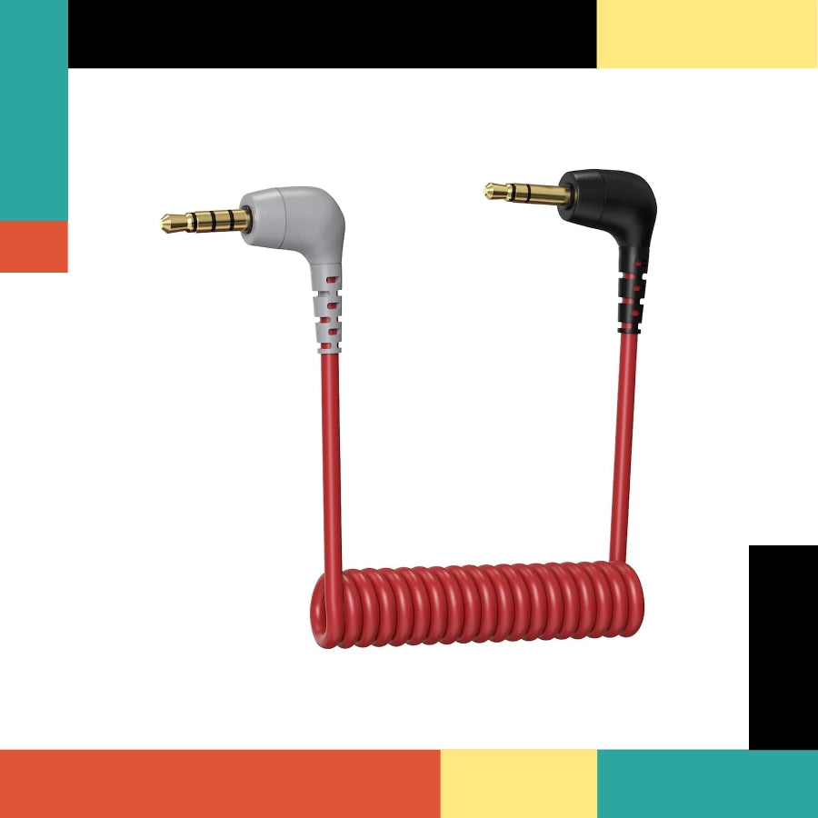 Coiled audio cable with 3.5mm connectors on a colorful background