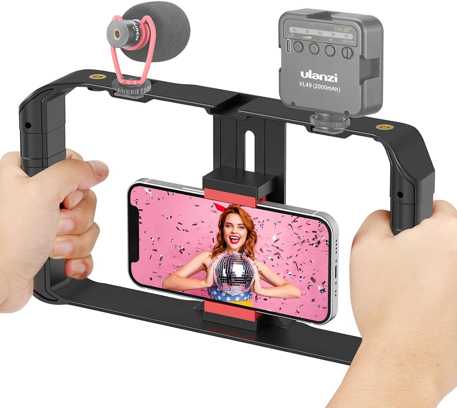 Handheld video camera stabilizer with smartphone displaying a person on screen, held by two hands.