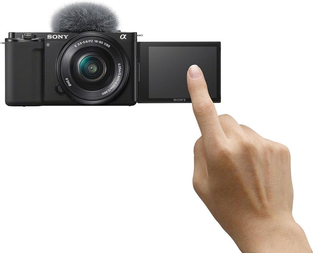 Sony camera with touch screen and hand interacting with it on a white background